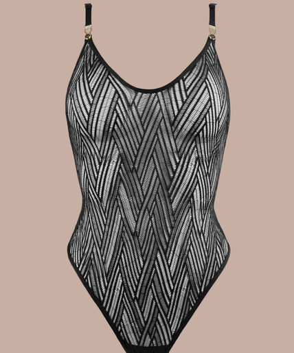 Atelier Amour – Clair Obscur Bodysuit Black Model wearing black geometric lace bodysuit with gold-tone strap clips, hand near forehead.