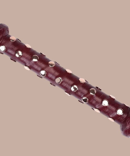 Liebe Seele Heavy Leather Flogger met Handvat met Noppen – Wijnrood Flogger with black falls, wine-red studded handle and wrist loop, curved arrangement.