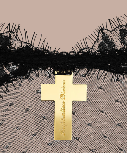 Maison Close/Scandale โ Inspiration Divine Open Back Lace Thong Body Black Inspiration Divine black Open Back Lace Thong Body with sheer floral lace and a gold-tone cross at the collar, front view on model.