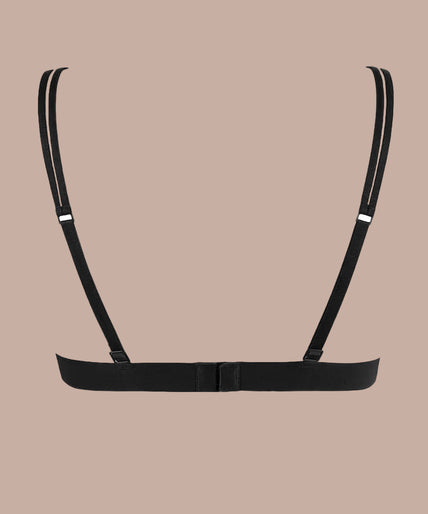 Atelier Amour – Menu Plaisir Triangel BH Zwart Model wearing black Menu Plaisir triangle bra with floral embroidery and matching thong, hand at her neck.