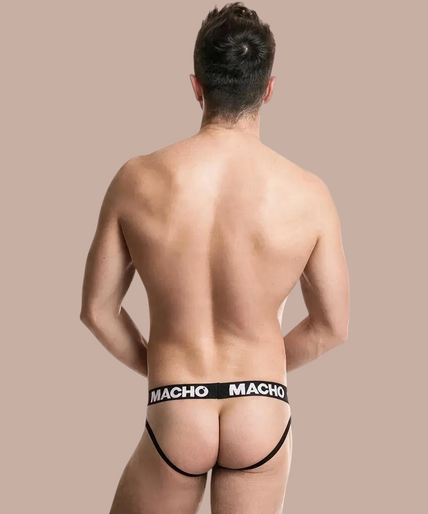 Macho – Mx26x2 Jock Schwarz/Rot S Pleasurements Macho MX26X2 jockstrap in zwart met rode tailleband gedragen door een model met gekruiste armen.