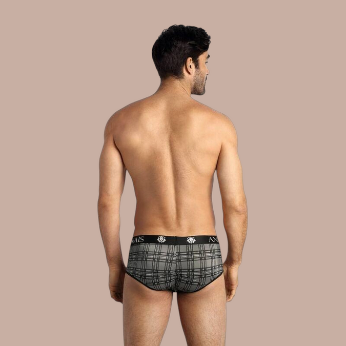 Pleasurements Anais Men Balance Brief met grijs ruitpatroon en zwarte tailleband gedragen door een man van achteren