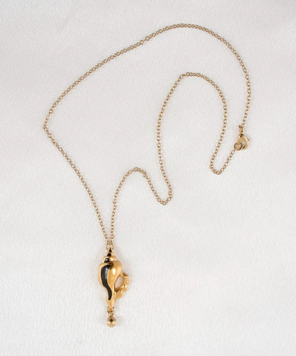 Sylvie Monthulé – Secret Passion Gold and Black Shell Pendant Gold Sylvie Monthulé Secret Passion gold-coloured shell pendant with black accents and a dangling bead on a chain.