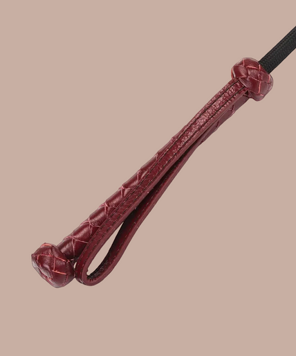 Liebe Seele wine red riding crop with heart-shaped tip, black shaft and braided handle with wrist loop.
