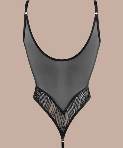 Model wearing black geometric lace bodysuit with gold-tone strap clips, hand near forehead.