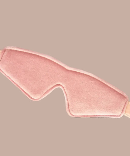 Front view of Liebe Seele Boudoir Amor blush pink blindfold with buckle strap and shaped nose cut-out.