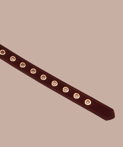 Dark red blindfold with stitched edges and adjustable buckle strap, front view.