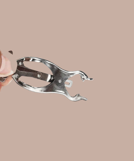 Pair of silver-tone clover nipple clamps joined by a chain, curved arrangement.