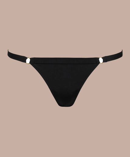 Model wearing black Fatale briefs and matching crossed-strap bra, front view with one arm raised.