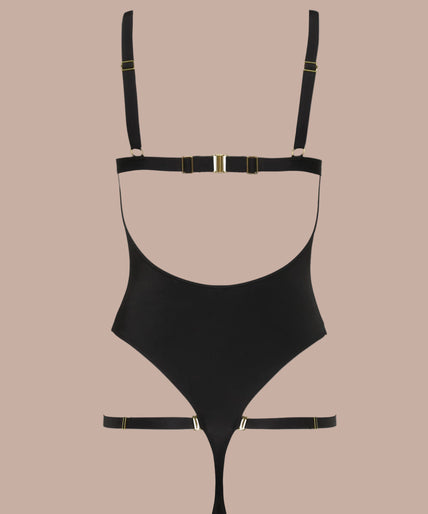 Side view of model wearing black Fatale bodysuit with strappy neckline and high-cut legs, one arm raised.