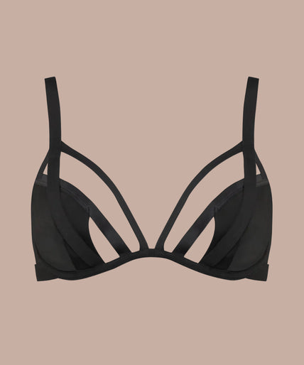 Side view of model wearing black Fatale wire bra with cutout straps and matching black bottoms.