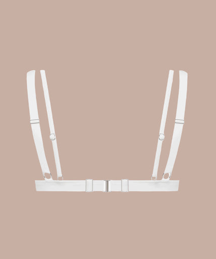 Front view of model wearing white Fatale triangle bra with cutout straps and matching white bottoms.