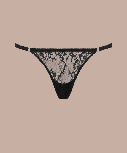 Inspiration Divine black Cross Micro Thong with a sheer floral lace front and narrow side straps, front view on model.