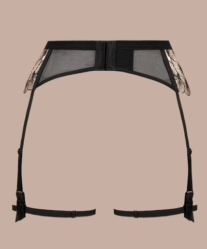 Model wearing black Menu Plaisir suspender belt with floral embroidery, thigh straps and matching lingerie.