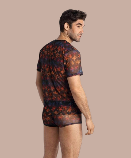 Pleasurements Anais Men Chill T-shirt met transparante stof en kleurrijk palmbladpatroon gedragen door een model