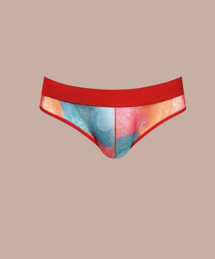 Pleasurements Anais Men Falcon slip met kleurrijk tie-dye patroon en rode tailleband gedragen door een model